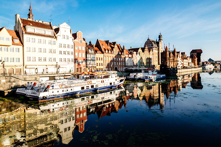 Some Polish buildings are along a river or canal.