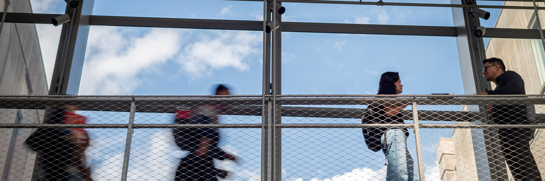 Students walking on the crosswalk in the HLS atrium.